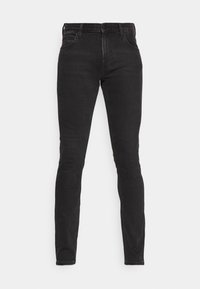 Svarta slim-fit jeans i denim med fem fickor och bälteshällor, visade platt mot en vit bakgrund.