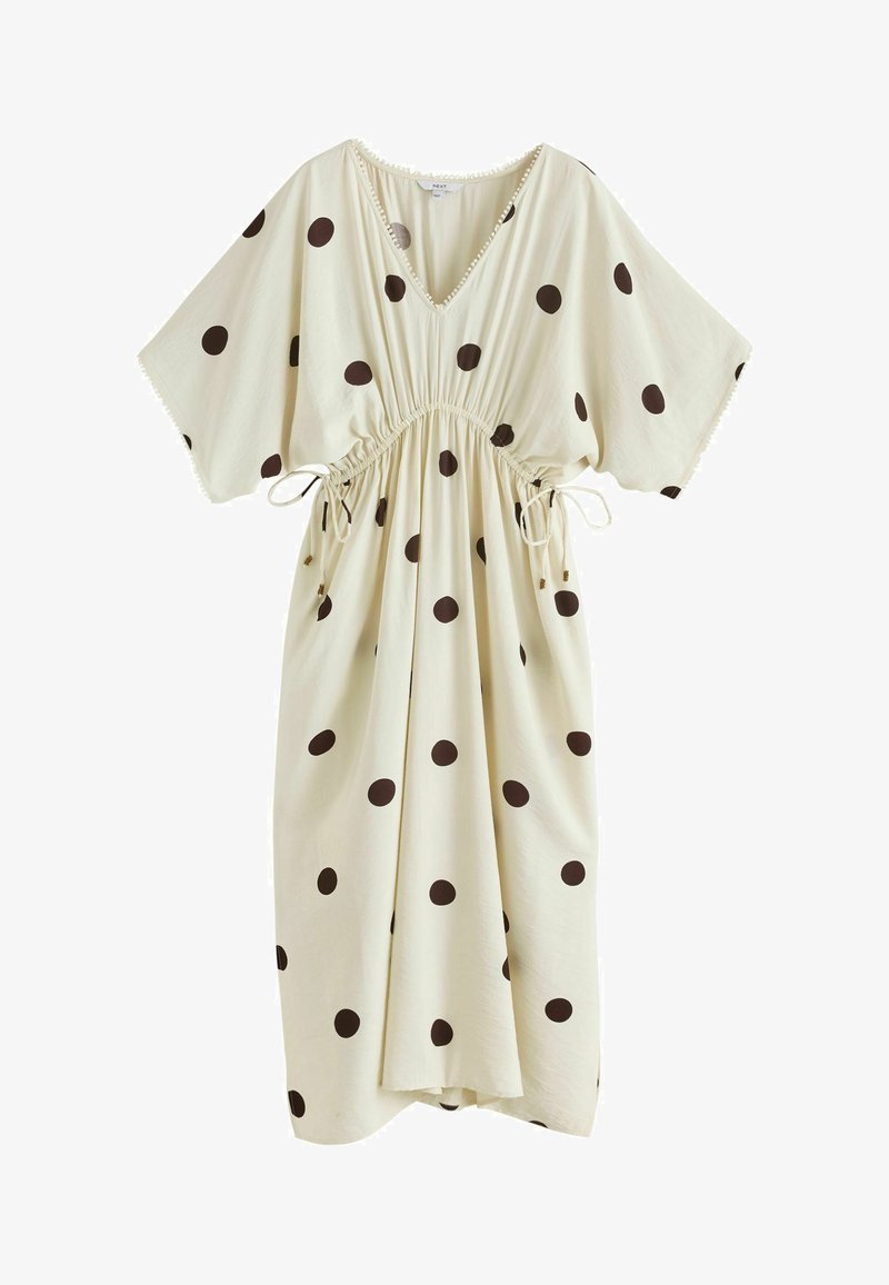 Robe midi crème à pois noirs, encolure en V, manches courtes larges et cordons ajustables à la taille.