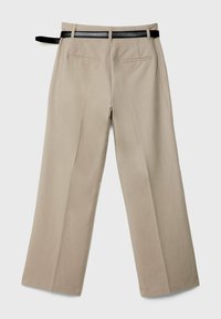 Pantalon beige coupé sur mesure avec poches passepoilées à l'arrière et ceinture noire, présenté à plat de dos sur un fond uni.