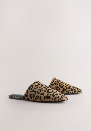 Chaussures sans lacets à imprimé léopard avec un bout pointu et une tige douce et texturée aux tons beige et noir. La semelle intérieure est sombre avec une bordure minimale.