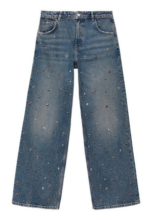 Jean en denim à jambes larges de couleur bleu clair, ornés d'étoiles métalliques et d'accents circulaires sur le tissu pour ajouter de la texture et des détails.