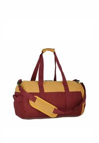 Red and yellow duffel bag with dual handles, adjustable strap, zipper closure, and textured fabric; rounded shape with side pocket.