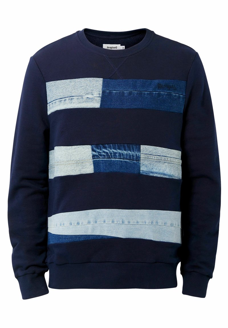 Sweat-shirt marine avec un design en patchwork en denim, présentant des bandes de tissu bleu clair et bleu foncé disposées en rangées horizontales et un col bordé.