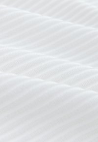 White ribbed fabric with evenly spaced raised horizontal ridges creating a soft textured surface.
