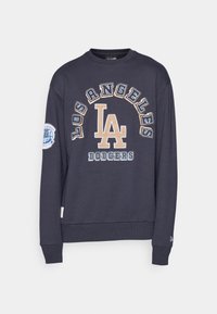 Sweatshirt bleu marine avec broderie "LOS ANGELES DODGERS" et logo "LA" en beige et blanc. Manches et ourlet côtelés, matériau en coton doux.