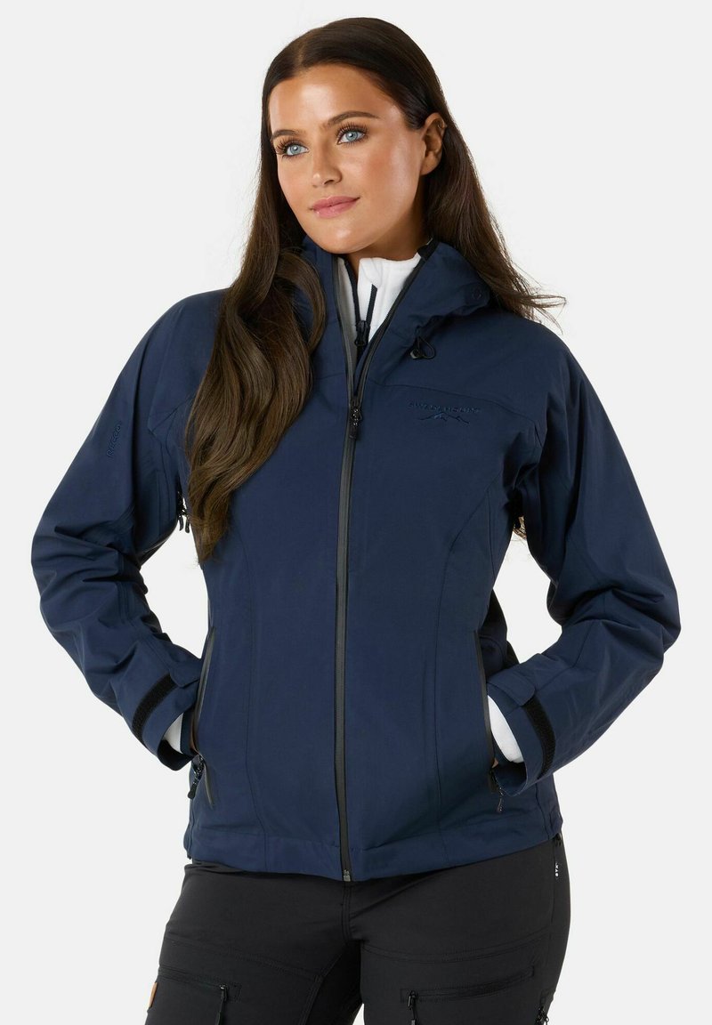 Navy blue waterproof jacket with a hood, front zipper, and elastic cuffs; features two side pockets and a logo on the chest.