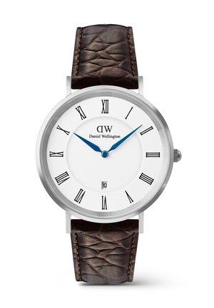 Round silver watch with white dial, black Roman numerals, blue hour and minute hands, date window at 6, and textured dark brown leather strap.