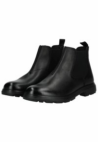 Botines Chelsea de cuero negro con paneles laterales elásticos, punta redonda y suela de goma texturizada, con lengüetas para facilitar el calzado.