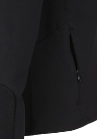 Black athletic top with a textured mesh panel, featuring a side zip pocket for storage and smooth fabric finish.