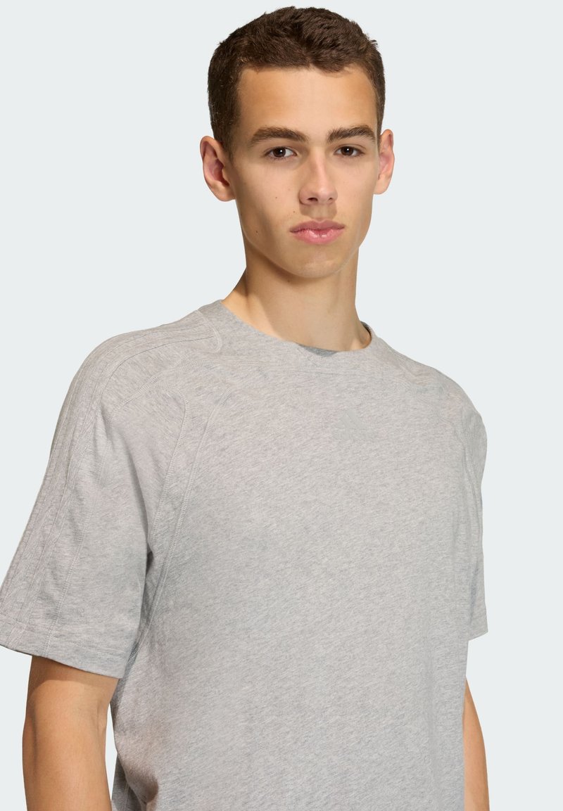 Gray short-sleeve t-shirt in a soft cotton blend with a crew neckline and subtle ribbed details along the shoulder seams.