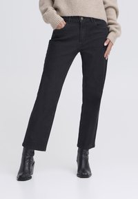 Black straight-leg jeans made of denim, featuring a mid-rise waist, front pockets, and a classic button closure.