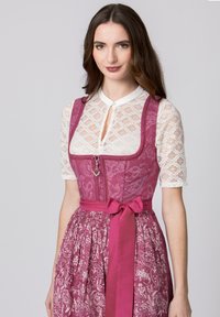 Traditional dress with a pink bodice featuring floral patterns, a lace white blouse, and a satin ribbon tie at the waist.