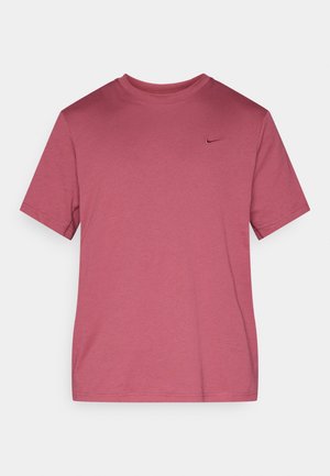 T-shirt rosa a maniche corte realizzata in morbido tessuto misto cotone, con scollo rotondo e un piccolo logo Nike nero sul petto a sinistra.
