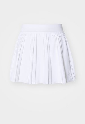 White pleated skirt with a wide elastic waistband. Made of a lightweight material, featuring clean lines and a subtle brand logo on the hem.