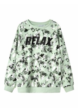 Mint green sweatshirt with a black "RELAX" print, featuring a textured pattern of black and white splotches, ribbed cuffs, and neckline.
