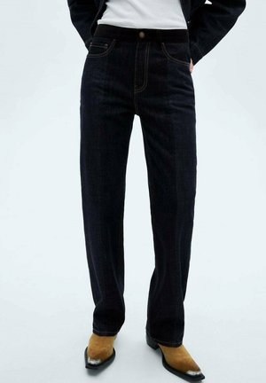 Dark blue denim jeans with a straight leg design, five pockets, and contrasting yellow stitching. The fabric appears thick with a textured finish.