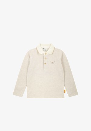 Beige poloshirt met lange mouwen, een crèmekleurige kraag, drie knopen en een geborduurd beerpatroon op de borst. Zacht materiaal en een recht afgewerkte zoom.