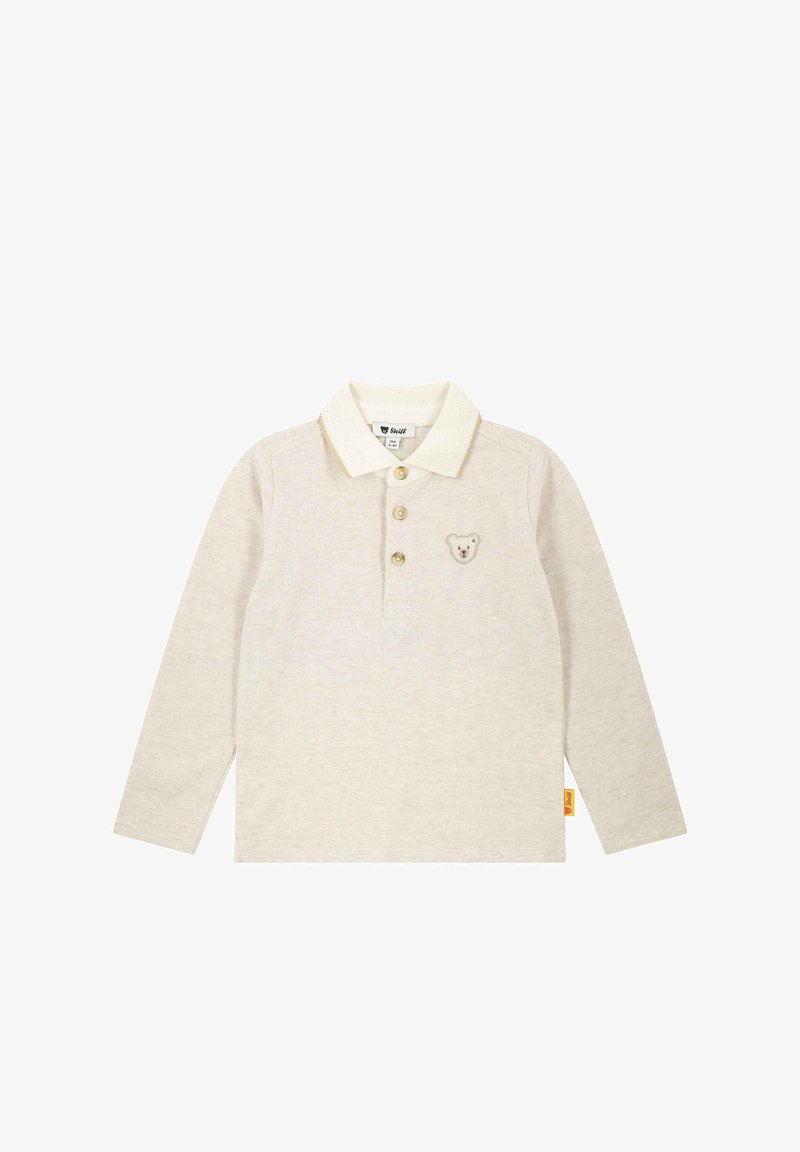 Beige poloshirt met lange mouwen, een crèmekleurige kraag, drie knopen en een geborduurd beerpatroon op de borst. Zacht materiaal en een recht afgewerkte zoom.
