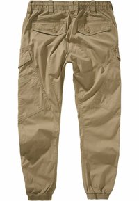 Pantalones cargo beige con una cinturilla elástica, múltiples bolsillos y un diseño de pierna ajustada. Hechos de una tela ligera y texturizada.