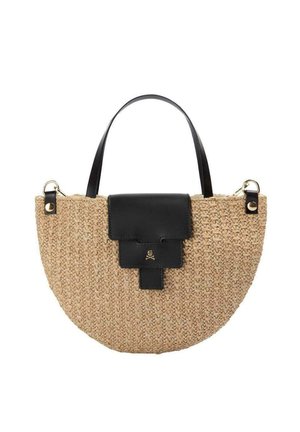 Bolso de mano de paja tejido en forma de media luna con solapa y asa de cuero negro, con pequeño detalle dorado de calavera y huesos cruzados en la solapa.