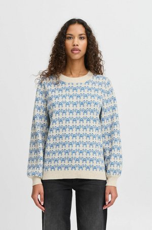 Hellcremefarbener Pullover mit blauen Schleifenmustern. Gerippte Bündchen und Saum. Weicher Stoff, runder Halsausschnitt und leicht lockere Passform.