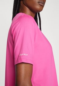 Pink short-sleeve shirt made of smooth fabric, featuring a crew neck and “ONLY PLAY” text printed in white on the left sleeve.