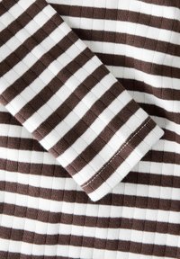 Braun-weißer gestreifter Stoff mit gerippter Textur. Verfügt über breite und schmale horizontale Streifen, mit sichtbarem Saum und Nähdetails.