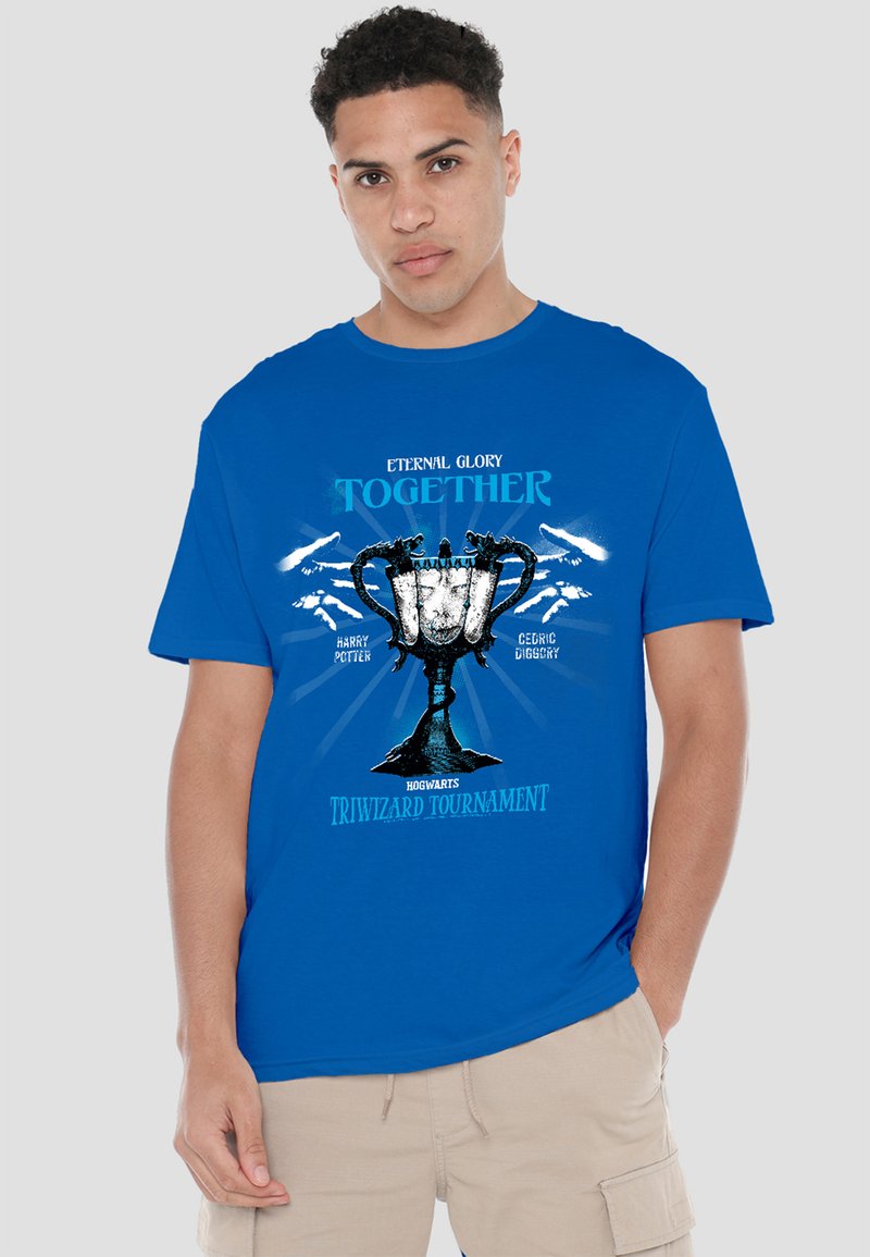 Man wearing blue t-shirt with Triwizard Tournament trophy and text referencing Harry Potter and Cedric Diggory.