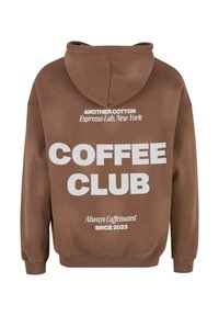 Sudadera de algodón marrón con bolsillo canguro, con texto en blanco: "COFFEE CLUB," "ANOTHER COTTON," y "Siempre Cafeinada Desde 2023."