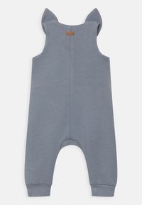 Szary bawełniany kombinezon bez rękawów z akcentami w postaci spiczastego kaptura. Posiada zaokrąglony dół i ściągacze dla wygody.