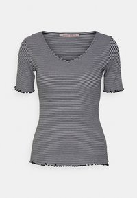 Striped short-sleeve top with a V-neck and ruffled edges. Main colors are black and white. Soft fabric with a fitted silhouette.