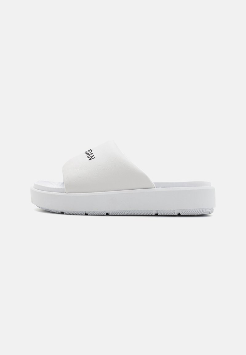 White slider sandals featuring a smooth synthetic upper, wide band, and rubber sole with textured grooves for traction.