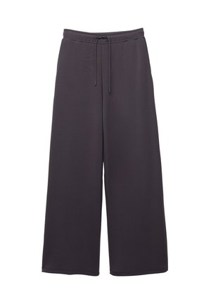 Pantalons larges gris foncé avec taille élastique et cordon de serrage, fabriqués dans un tissu doux, présentés sur un fond blanc.