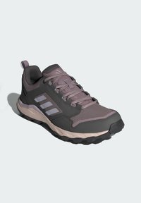 Zapatos de senderismo para hombre en gris oscuro y lavanda. Cuentan con una parte superior de malla, suela de goma, collar acolchado y detalle del logo de tres franjas.