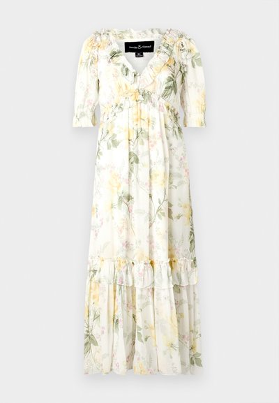 Blumenkleid im Maxistil aus weichem, leichtem Stoff. Merkmale: weiße Basis mit gelben und grünen Mustern, Rüschensäumen und einem geschichteten Saum.