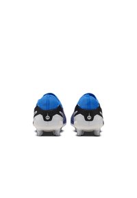 Botas deportivas de color azul y negro con un diseño de perfil bajo, material texturizado y tacos transparentes en la suela para mayor tracción.
