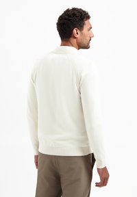 Licht crèmekleurig sweater met een kraag, ribbelboorden en zoom. Gekenmerkt door een gladde textuur, ontworpen in een slanke pasvorm. Beperkte zichtbare branding.