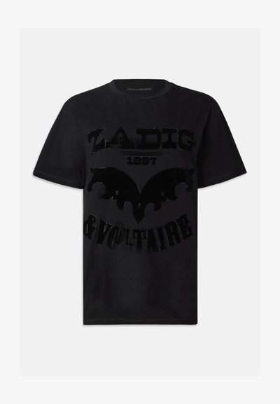 Must musta särk, millel on läikiv must graafiline print tekstiga "ZADIG 1997 & VOLTAIRE" ja nahkhiirekujuline disain. Lühikesed varrukad.