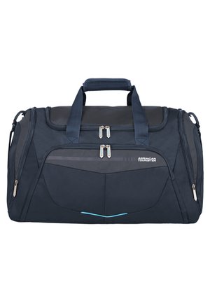Borsa da viaggio blu scuro con manici doppi, cerniere argentate, dettagli in rete e una sottile striscia blu sul davanti, realizzata in tessuto resistente.