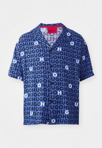 Short-sleeve shirt in blue with a repeating logo pattern in dark blue, light blue, and white. Features a collar and buttons down the front.