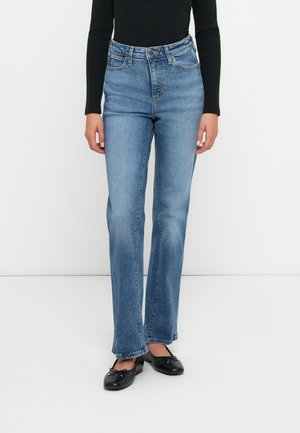 Höga blå denimjeans med rak ben, blekt tvätt, fem fickor och metallknappsstängning. Matchas med svarta ballerinas.