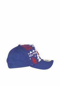 Casquette bleue en tissu tricoté à motifs rouge et blanc, avec une visière plate et un patch logo sur le côté.