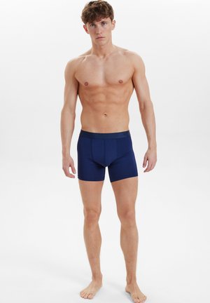 Mørkeblå boxer briefs lavet af blødt stof, med en behagelig elastisk talje og en tætsiddende pasform, designet til hverdagens brug.