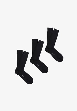 Tre paia di calzini neri a coste disposti uno accanto all'altro, ciascuno con la parola "PEROFIL" stampata vicino all'area delle dita.