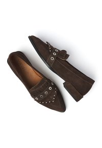 Bruine suede instappers met een spitse neus, decoratieve franjes, metalen grommets en een lage blokhak. Gladde binnenvoering.