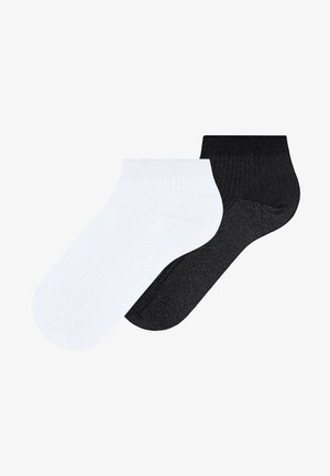 Pair of ankle socks, one white and one black, displayed flat against a white background.
