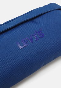 Levi's® SMALL BANANA SLING HEADLINE LOGO UNISEX - Torbica za okoli pasu - royal blue