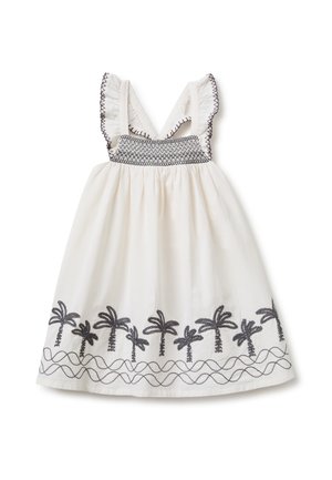 Vestido blanco sin mangas con patrones de palmeras cosidos en negro a lo largo del borde y detalles de costura negra en las tiras de los hombros con volantes y en el pecho.