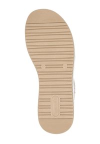Gummisohle mit strukturiertem Muster, das horizontale Rillen und subtile Markierungen aufweist. Die Farbe ist ein helles Beige und die Form ist rund.