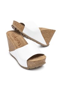 White wedge sandals with a cork base, featuring a wide front strap and textured footbed. Lightweight design suitable for casual wear.